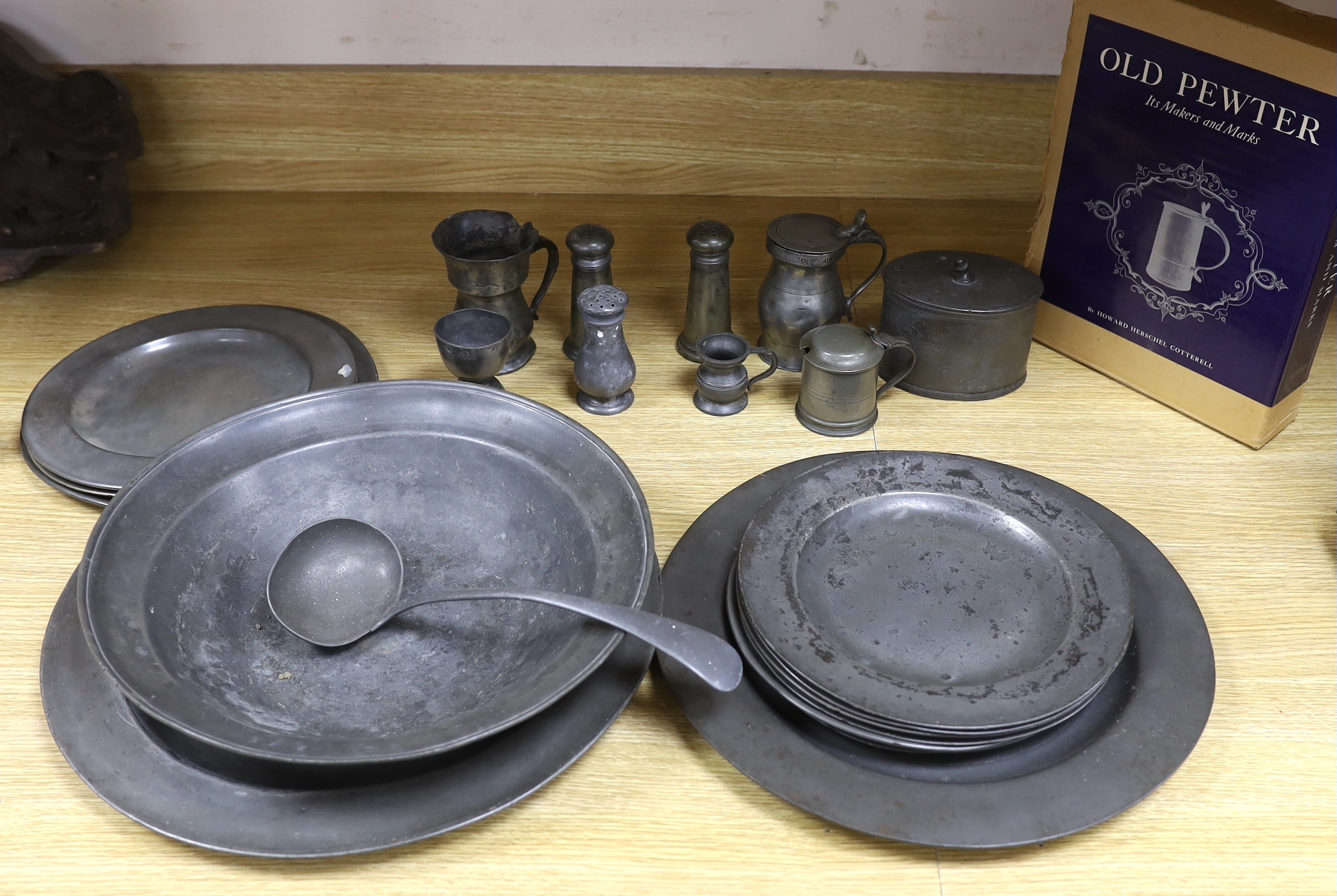 Pewter ware; a collection of plates, spoon cruet, jug, box, a large bowl, etc., bowl 34cm diameter (19)